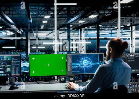 Data center engineer using green screen computer to run AI forecasting simulations, tracking performance. Server hub worker using mockup PC to integrate machine learning APIs into software platforms Stock Photo