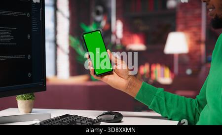 Black guy interacting with intelligent AI chatbot on pc next to copy space screen, using smart innovative system. Machine learning enhances efficiency through advanced algorithms. Camera A. Stock Photo