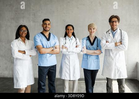Multiracial medical team posing at clinic while having team-building Stock Photo