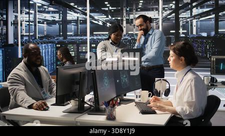 Data center engineers performing maintenance on blade server units used for artificial intelligence processing. IT professionals manage data center arrays used for machine learning training, camera A Stock Photo