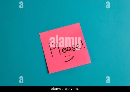 Handwritten note on red background reads with smiley face symbolic expression of affection and emotional warmth. Stock Photo