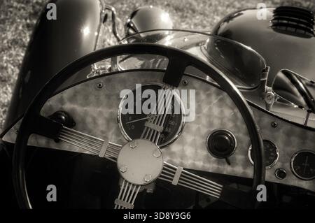 Vintage roadster steering wheel and dashboard in sepia tone Stock Photo