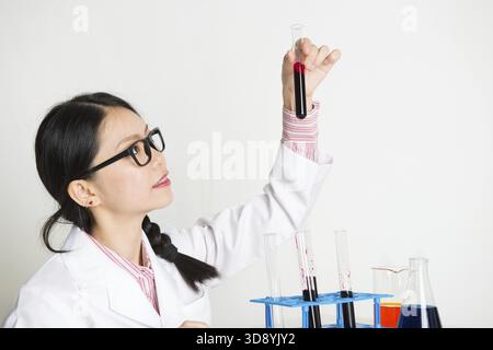 Portrait of young woman scientists doing experiment in the lab with chemistry liquid Stock Photo