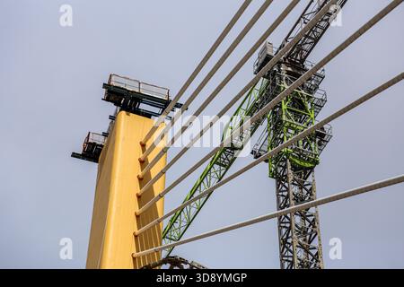 Cable-Stayed Bridge Construction with Tower Crane Under Blue Sky Stock Photo
