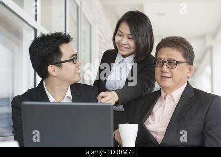 Asian business team meeting. Group of businesspeople having discussion at restaurant cafe Stock Photo