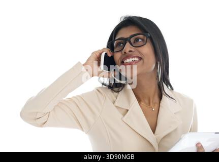 Indian woman on the phone. Smart Indian business woman talking on the phone smiling happy isolated on white background. Beautiful Asian female model Stock Photo