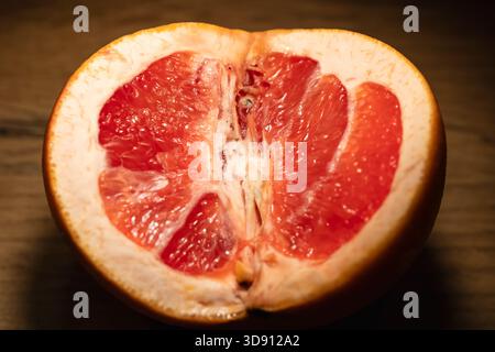 close-up of halved grapefruit on wooden surface  Stock Photo
