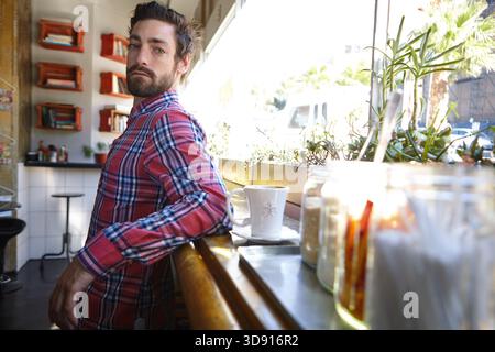 Owner, coffee shop and portrait of man in small business, customer service or hospitality industry. Serious person, cafe and confident entrepreneur in Stock Photo