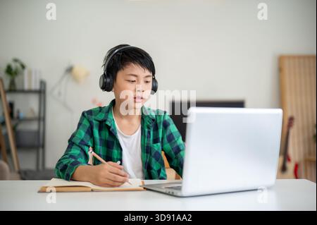 children education boy wearing headphone with laptop Stock Photo - Alamy