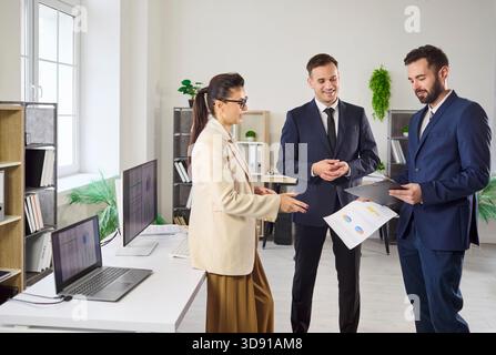 Business colleagues discussing reports in office, strategy planning and teamwork Stock Photo