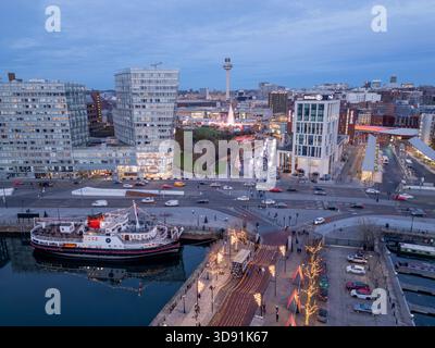 LIVERPOOL, MERSEYSIDE, ENGLAND - NOVEMBER 21, 2025: Historic Royal Daffodil ferry moored in Canning Dock with the illuminated Liverpool One at dusk, E Stock Photo