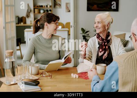 Senior Woman Smiling While Interacting with Middle Aged Woman Stock Photo