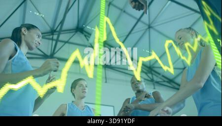 Huddling five players wearing light blue jerseys discussing strategy in gym, neon waveform overlay Stock Photo