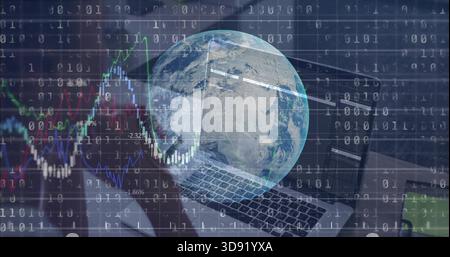 Displaying digital globe overlaying laptop keyboard at desk, with binary code and financial charts Stock Photo
