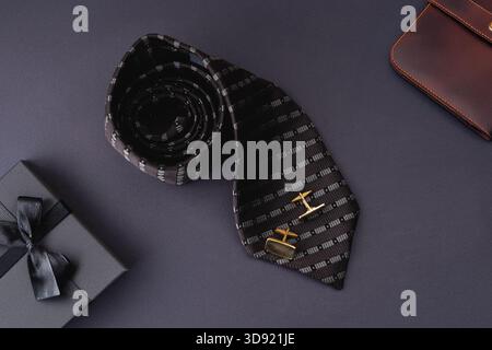 Men's Day. Tie and cufflinks on a blue background. Stock Photo