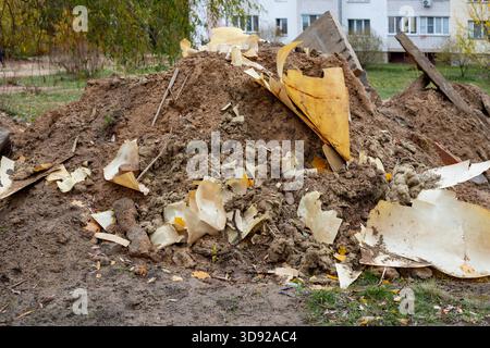 Cardboard, paper, sand, and construction debris at the construction site. Waste sorting, hazardous waste disposal, and recycling. Stock Photo