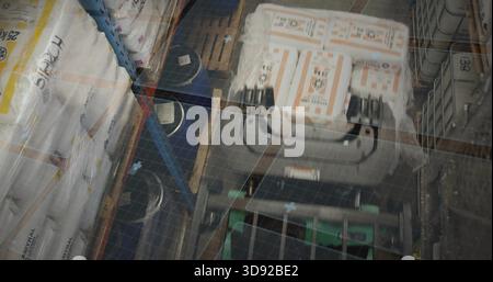 Centering pallet stacked white orange-labeled cartons sitting in warehouse aisle, with pallet jack Stock Photo