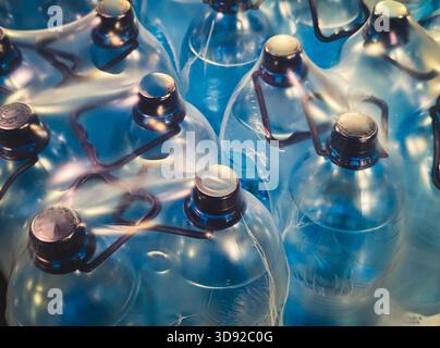 close up abstract pattern of large plastic water cooler bottles in blue tones Stock Photo
