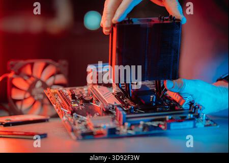 Man assembles a computer system unit at home Stock Photo