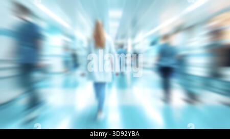 Blurred hospital scene with doctors moving, busy medical environment in clinic corridors Stock Photo