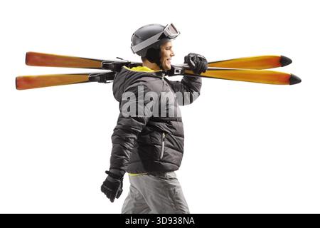 Man walking and carrying skis isolated on white background Stock Photo