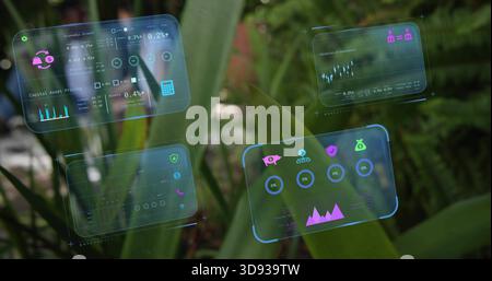 Floating four translucent holographic data panels over garden leaves, showing piggy-bank icons Stock Photo