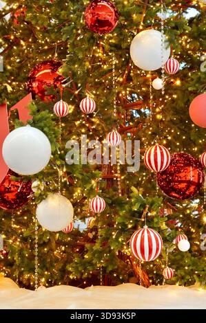 Christmas tree decorated with red and white balls and garlands. Christmas background Stock Photo