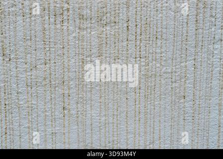Rough white wall texture with vertical drips lines and subtle grunge details. Abstract background for design, construction, interior, patterns, and ar Stock Photo