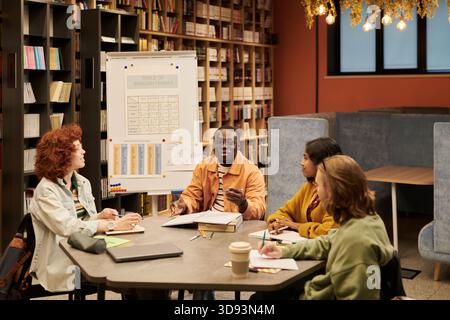 Diverse Young People Collaborating during English Language Learning Workshop Stock Photo