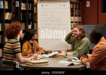 Multiethnic Young People Studying French Language Together in Library Setting Stock Photo