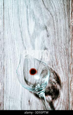 Red wine in a broken wine glass Stock Photo
