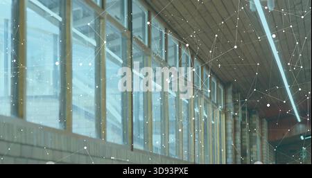 Showing row of tall glass windows with wooden frames in interior corridor, with network overlay Stock Photo