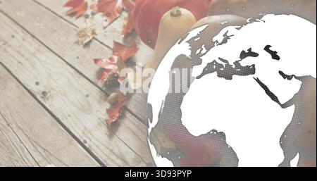 Overlaying globe graphic halftoning Europe Africa over wooden tabletop with pumpkins squash leaves Stock Photo