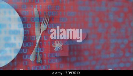 Showing table arrangement on red table with round plate, gift box, heart token and binary overlay Stock Photo