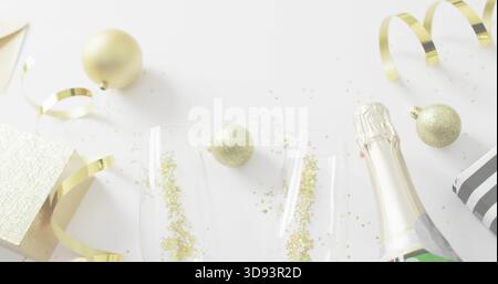 Displaying festive drink setup featuring two champagne flutes and sparkling bottle on white surface Stock Photo