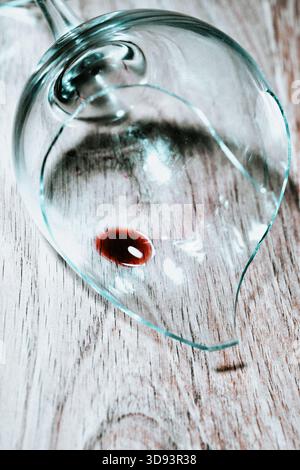 Red wine in a broken wine glass Stock Photo