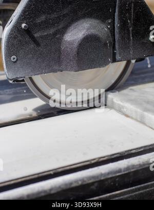Cutting stone tiles with a tile cutter. Selective focus. work. Stock Photo