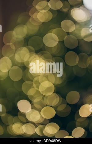 A soft, golden bokeh background created by out-of-focus festive lights, offering a warm and atmospheric holiday glow perfect for seasonal designs and Stock Photo