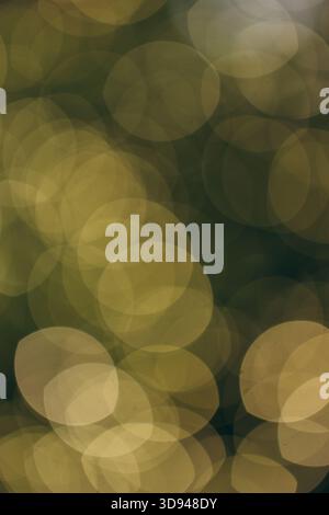 A soft, golden bokeh background created by out-of-focus festive lights, offering a warm and atmospheric holiday glow perfect for seasonal designs and Stock Photo