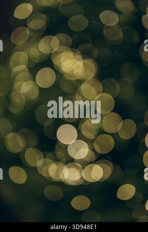 A soft, golden bokeh background created by out-of-focus festive lights, offering a warm and atmospheric holiday glow perfect for seasonal designs and Stock Photo