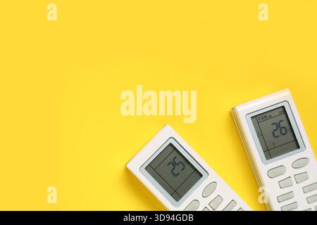 Air conditioner remote controls on yellow background Stock Photo