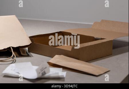 Close up shot of paper, cardboard, and plastic packaging, highlighting the need for recycling, waste sorting, and copy space on the box Stock Photo