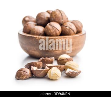 Tasty macadamia nuts in bowl isolated on a white background. Stock Photo