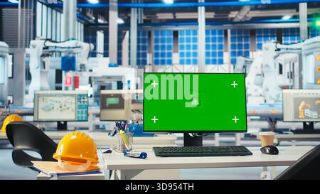Isolated screen PC in photovoltaics factory used to monitor performance of robot arms manufacturing solar panels. Chroma key mockup computer in empty facility used to inspect solar plant machinery Stock Photo