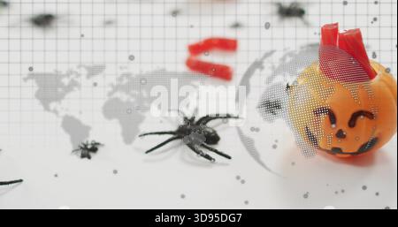 Showing pumpkin with red wrap sitting on grid backdrop, with two spiders, map overlay, copy space Stock Photo
