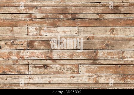 Close-up of weathered wooden planks showing rich grain, knots, embedded nails, and natural rustic texture with aged variation Stock Photo