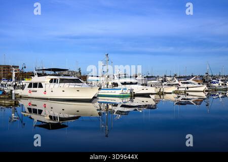 Luxury pleasure craft and fishing boats moored together in harbor Stock Photo