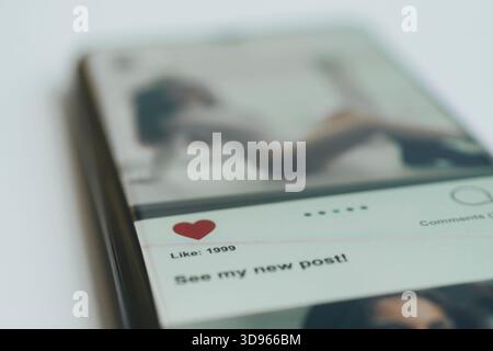 social network on the smartphone screen. Social media concept. All the graphics on the screen are made up. Stock Photo