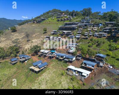 Aerial view of a small stilt house and circular fishing stakes in the ...