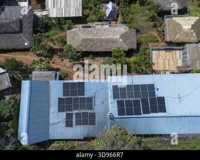 Aerial view of rural village with solar panel on roof, symbol of progress and sustainable energy. hopeful look at technology meeting tradition in remo Stock Photo
